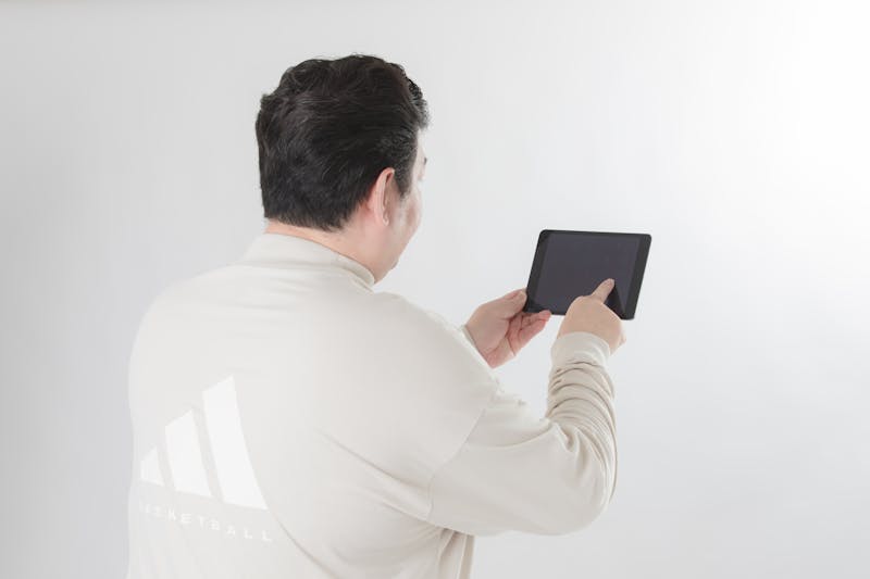 hand performing multi-touch gesture on tablet with glowing contact points visualization, heat map style