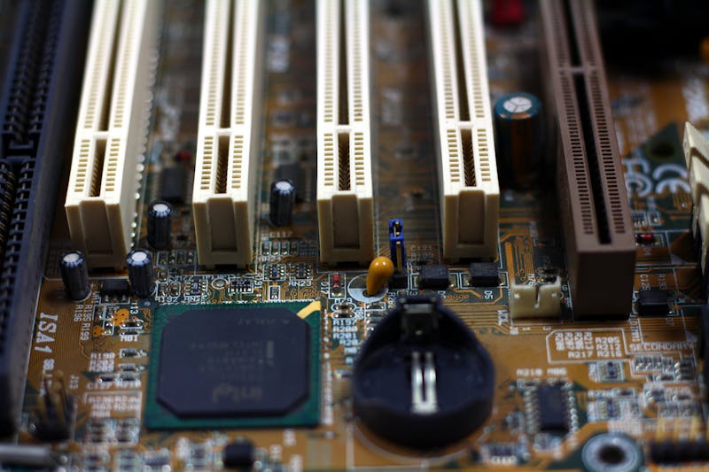 closeup of smartphone motherboard showing MEMS sensor chip under magnification