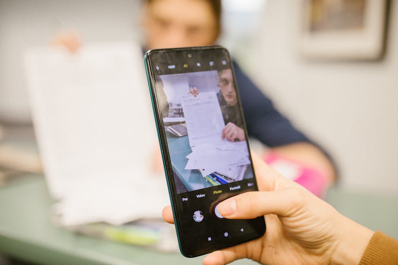 closeup of hand holding phone during continuous vibration test showing motion blur
