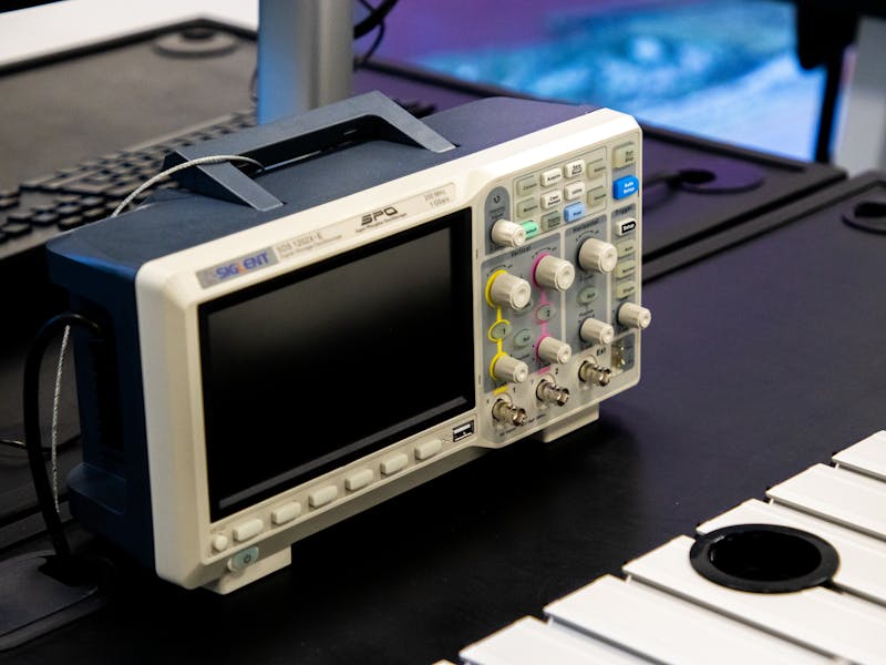 User adjusting monitor settings while viewing HDR test patterns on screen