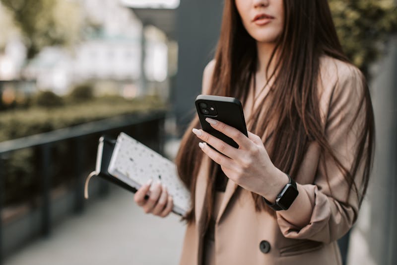 person holding smartphone checking vibration settings before entering a meeting room