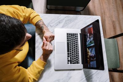 laptop webcam close up person on video call background blurred office desk