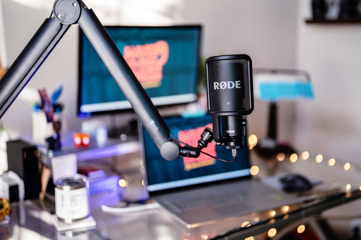 remote work setup, podcast recording equipment, laptop with external mic